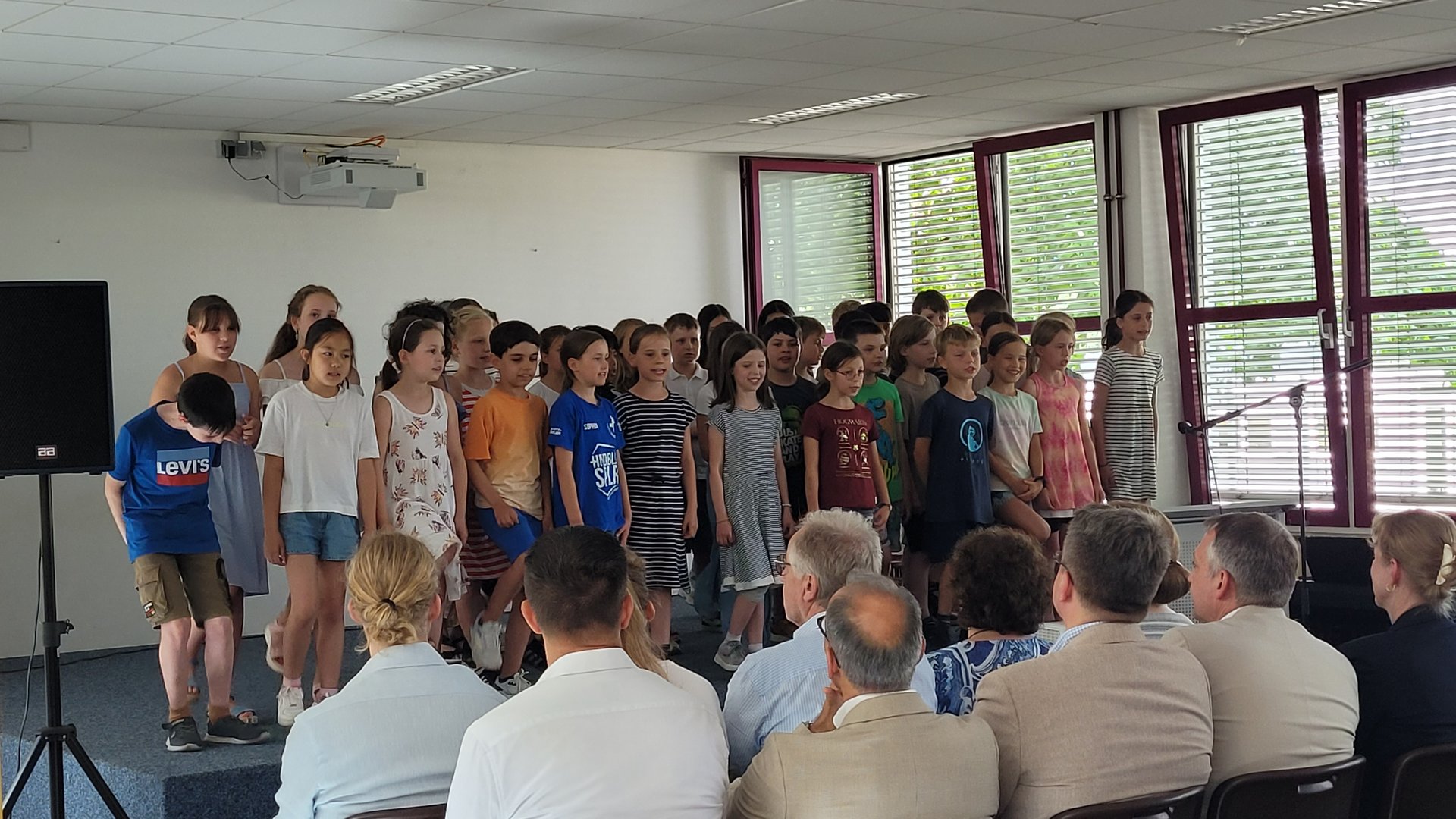 Ein Kinderchor singt auf der Bühne.
